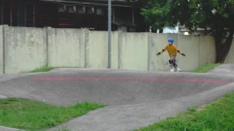 Tracking Shot of Girl Roller Skating along Asphalt Pumptrack Bumps in Kőbánya Stock Footage 346881709
