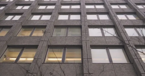 Tracking shot of gray office building and windows looking upwards in downtown 4K 스톡 동영상 102791290