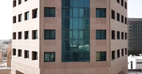 Tracking shot from the ground to the top of a building with window cleaners Stock Footage 145390491