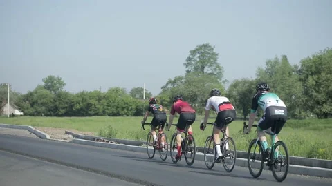 Tracking shot of a group of cyclists on country road. 動画素材 142875235
