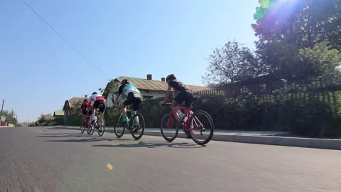 Tracking shot of a group of cyclists on country road. Vídeos de archivo 142875950
