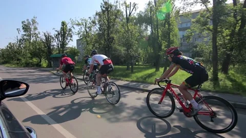 Tracking shot of a group of cyclists on country road. Stock Footage 142881977
