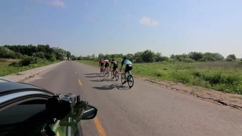 Tracking shot of a group of cyclists on country road. 動画素材 142883561