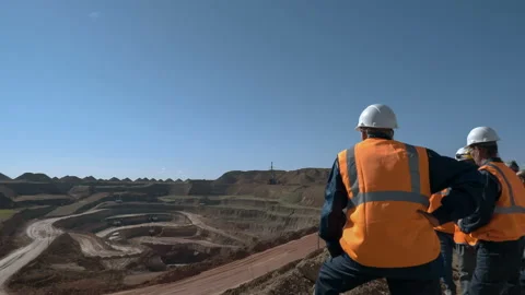 Tracking shot of a group of workers in overalls actively speaking on board a Stock Footage 87730602