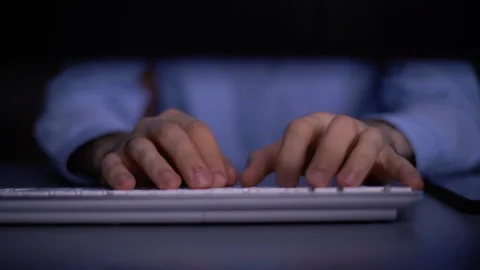 Tracking shot of hands of unrecognizable man working typing on wireless keyboard Video stock 146179028