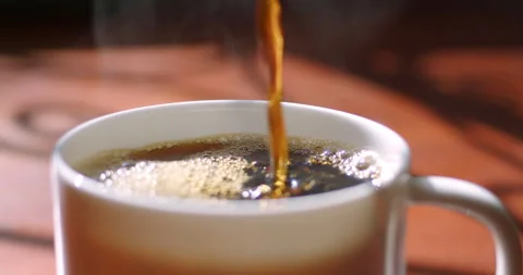 Tracking Shot of hot coffee poured into cup Stock Footage 230207169