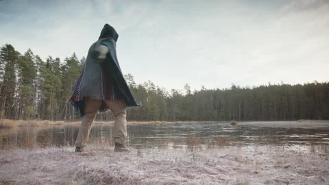 TRACKING shot of an ice bather warming up with qigong and tai chi before Video stock 166442172