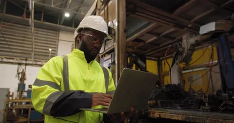 Tracking shot of industrial engineer walking in manufacturing industry. Stock Footage 183333763