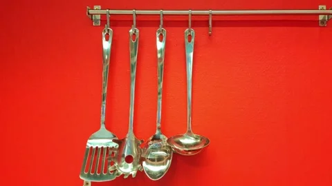 Tracking shot of kitchen utensils on a red wall. Stock Footage 317166101