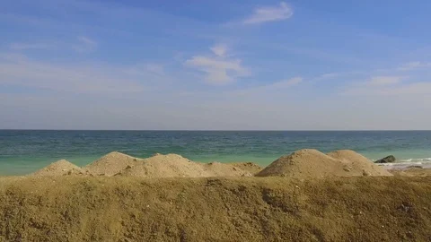 Tracking shot left side view of driving alongside a beautiful remote sandy beach Stock Footage 111886702