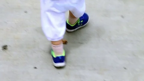 Tracking shot of little child's steps walking Stock Footage 76738271