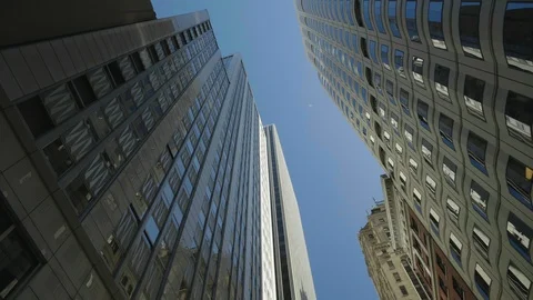 TRACKING SHOT LOOKING UP AT SKY SCRAPERS, WITH BLUE SKY Stock Footage 127470785