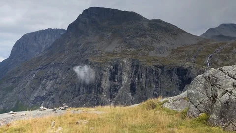 Tracking shot, looking at stacks of rocks, on a mountain ledge, high Stock Footage 101856414