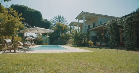 Tracking shot of a luxurious backyard garden and pool Stock Footage 75763875