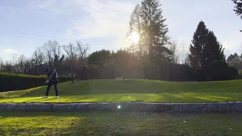 Tracking Shot on an Male Golfer Making a Practice Golf Swing on the Tee Box Stockbeeldmateriaal 267734341