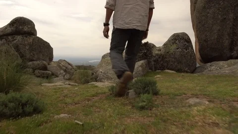 Tracking shot of man arriving to cliff. Stock Footage 75302551