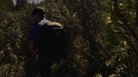 Tracking shot of man hiking in the mountains. Stock Footage 75161053
