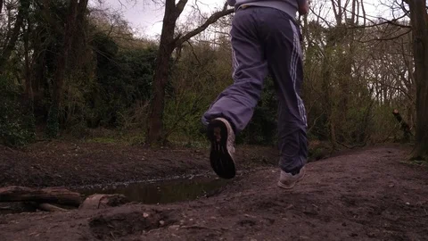 Tracking of shot of Man Running in Forrest. Stock Footage 89306461