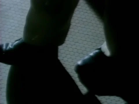 Tracking shot of man slowly walking on tile floor, 1980s Stock-Footage 260258638