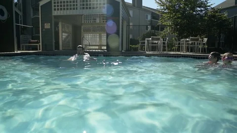 Tracking shot of a man swimming in a pool 動画素材 76234200
