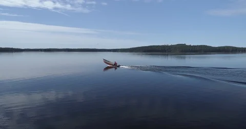 Tracking shot of a man on a tranquil lake Stock Footage 85888737