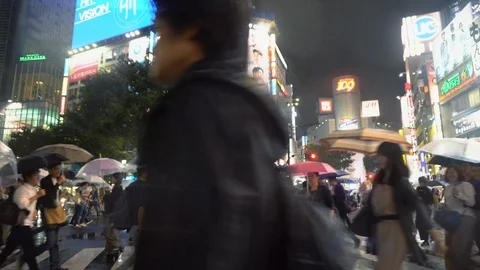 Tracking Shot of Man Walking Through Crowds At Shibuya Crossing in Tokyo, Japan Stock Footage 105058407