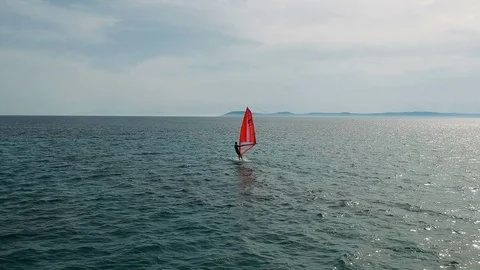 Tracking shot of man on windsurf board catching the wind Video stock 110730168