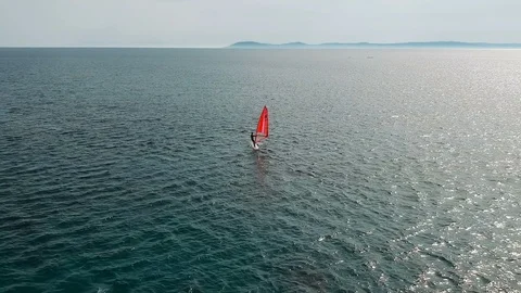 Tracking shot of man on windsurf board Stock Footage 110750429