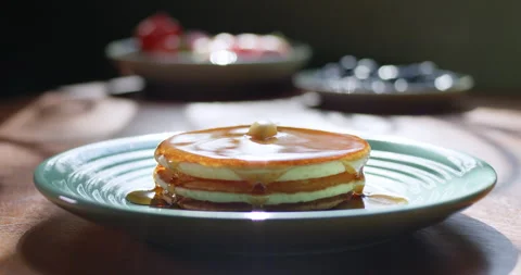 Tracking Shot of maple syrup being poured over hot pancakes Stock Footage 230207886