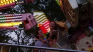 Tracking Shot, Medium Shot Of Young Couple On Amusement Park Ride / American Stock Footage