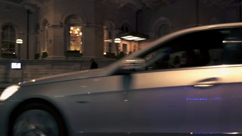 Tracking shot of a Mercedes E-Class car driving on London city streets at night Stock Footage 121618359