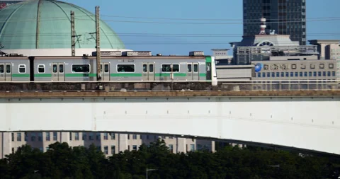 Tracking shot of metro train moving on bridge against National Assembly building Stock Footage 295058651