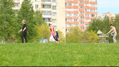 Tracking shot of the mother with a boy walking on the path 動画素材 5328221