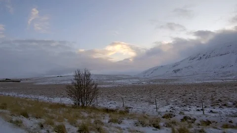 Tracking shot moving fast in a snowy winter landscape near a mountain cloudy sky Stock Footage 93402188