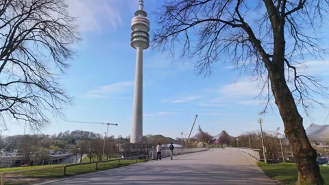 Tracking shot moving forward through Munich’s Olympic park Stock Footage 308932646