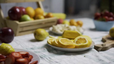 Tracking shot moving smoothly across counter filled with various fruit Stock Footage 341185442