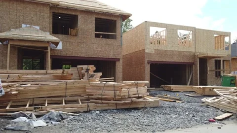 Tracking shot of new construction of frame wood homes in the suburb 4K Stock Footage 136908208