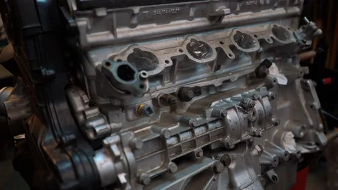 Tracking shot next to a racing engine long block ready for dissassembly Stock Footage 99337557