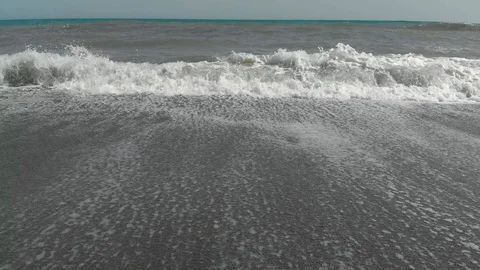 Tracking shot oceans waves at the beach Stock Footage 129504262