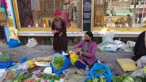 Tracking shot, old female vegetable seller on Leh street market. Stock Footage 257097502
