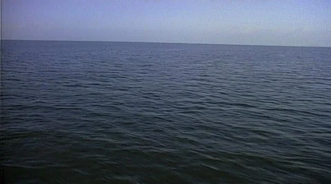 Tracking shot over calm ocean water passing small boat - 3 different takes 스톡 동영상 29804394