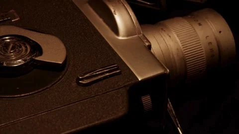 Tracking shot over vintage camera body and rotating reels Stock Footage 329746149