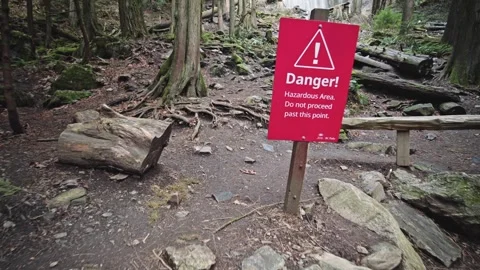 Tracking shot past a red danger sign at the base of Bridal Veil Falls in Video stock 333012625