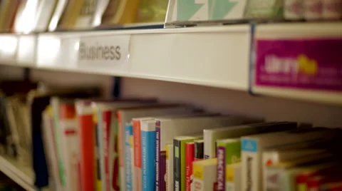 Tracking Shot Past Someone Choosing Books Stock Footage 44250581