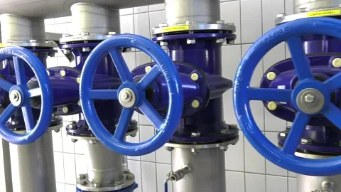 Tracking shot of a pipe system with shut-off valves in the waterworks 動画素材 234998870