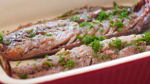 Tracking shot of pouring sauce over the top of salmon steak on white plate Stock Footage 134621271