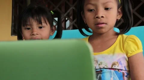 Tracking Shot, R to L, of Two Cute Indian/Hispanic Girls with Laptop Computer Stock Footage 58561149
