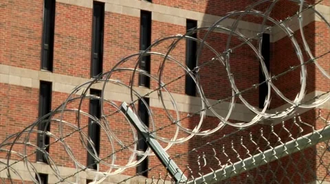 Tracking Shot of Razor Wire in front of Jail Stock Footage 50138570