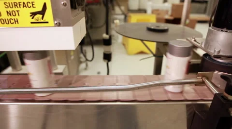Tracking shot of a rectangular plastic bottles moving along a conveyor belt. Stock Footage 50522936