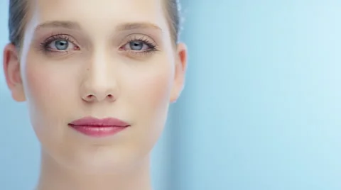 Tracking shot from right to left from attractive blinking woman Video stock 62244771